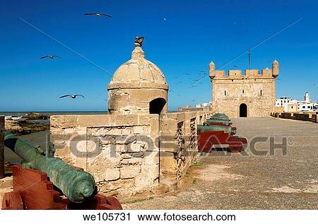 Sqala du Port fortress with cannons and Essaouira city with Sqala de la Ville and North Bastion in the distance View Large Photo Image Stock Image - Sqala du Port fortress with cannons and Essaouira city with Sqala de la Ville and North Bastion in the distance. Fotosearch