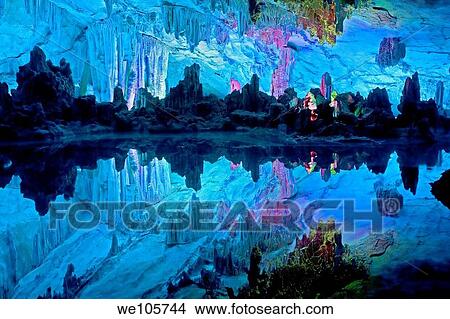 The beautifully illuminated Reed Flute Caves displaying the ´Crystal Palace of the Dragon King´ formations Located in Guilin, Guangxi Provine, China View Large Photo Image Picture - The beautifully illuminated Reed Flute Caves displaying the ´Crystal Palace of the Dragon King´ formations Located in Guilin, Guangxi Provine, China. Fotosearch