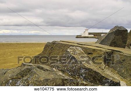 The lighthouse in Balbriggan, Co Dublin, Ireland, framed by rocks in the foreground View Large Photo Image Stock Photography - The lighthouse in Balbriggan, Co Dublin, Ireland, framed by rocks in the foreground. Fotosearch