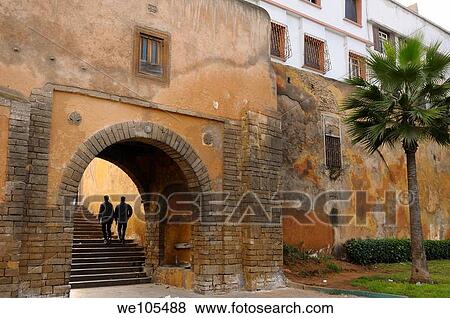 Two young men walking up the steps of the East entrance gate to the Old Medina Casablanca, Morocco View Large Photo Image Stock Photo - Two young men walking up the steps of the East entrance gate to the Old Medina Casablanca, Morocco. Fotosearch