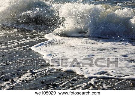 Wind driven waves slowly eroding stones to grains of sand. View Large Photo Image Stock Photo - Wind driven waves slowly eroding stones to grains of sand.. Fotosearch