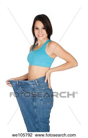 Woman showing weight loss by wearing an old pair of jeans View Large Photo Image Stock Image - Woman showing weight loss by wearing an old pair of jeans. Fotosearch