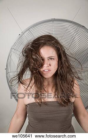 Young woman in front of a fan View Large Photo Image Stock Image - Young woman in front of a fan. Fotosearch