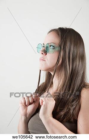 Young woman wearing sunglasses View Large Photo Image Stock Image - Young woman wearing sunglasses. Fotosearch