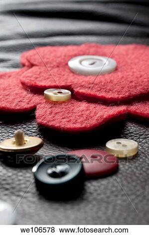 A red fleece flower with button center and miscellaneous buttons View Large Photo Image Stock Photo - A red fleece flower with button center and miscellaneous buttons. Fotosearch