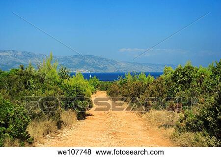 A road leading to Digidaga Bay on Kabal Peninsula north of Stari Grad on Hvar Island, Croatia Brac Island is seen in the distance View Large Photo Image Stock Photo - A road leading to Digidaga Bay on Kabal Peninsula north of Stari Grad on Hvar Island, Croatia Brac Island is seen in the distance. Fotosearch
