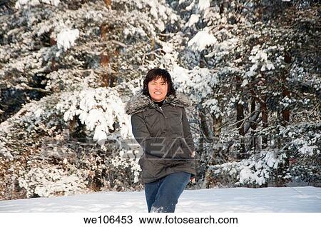 Stock Image - A South Korean woman has fun in the snow. Fotosearch