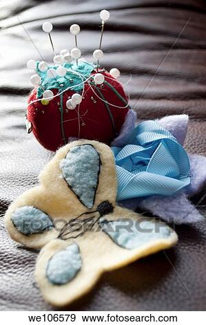 A tomato pin cushion and a flower and butterfly sewn by hand View Large Photo Image Stock Photo - A tomato pin cushion and a flower and butterfly sewn by hand. Fotosearch