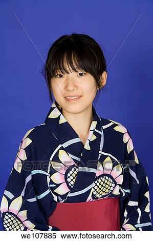 Stock Photography - Asian teen dressed in a Kimono on a blue background. Fotosearch