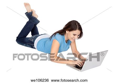 Stock Photograph - Attractive young girl using notebook computer on white background. Fotosearch