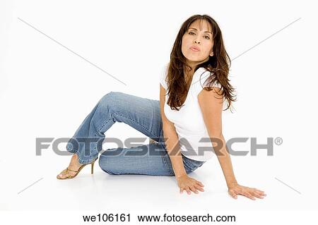 Beautiful Brazilian or Hispanic woman in casual clothes sitting on a white background View Large Photo Image Stock Image - Beautiful Brazilian or Hispanic woman in casual clothes sitting on a white background. Fotosearch