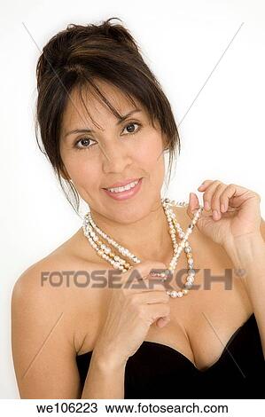 Stock Image - Beautiful Brazilian or Hispanic woman in a black evening gown on a white background. Fotosearch
