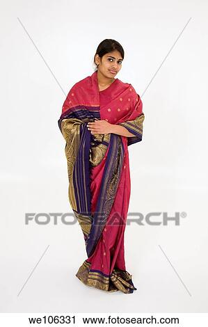 Beautiful Hindu teenager dressed in a traditional Sari dress View Large Photo Image Stock Image - Beautiful Hindu teenager dressed in a traditional Sari dress. Fotosearch