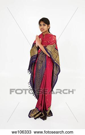 Stock Image - Beautiful Hindu teenager dressed in a traditional Sari dress. Fotosearch