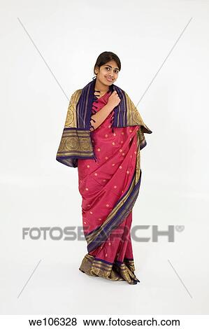 Beautiful Hindu teenager dressed in a traditional Sari dress View Large Photo Image Stock Photo - Beautiful Hindu teenager dressed in a traditional Sari dress. Fotosearch