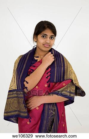 Beautiful Hindu teenager dressed in a traditional Sari dress View Large Photo Image Stock Photo - Beautiful Hindu teenager dressed in a traditional Sari dress. Fotosearch