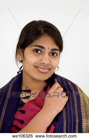 Beautiful Hindu teenager dressed in a traditional Sari dress View Large Photo Image Stock Photograph - Beautiful Hindu teenager dressed in a traditional Sari dress. Fotosearch