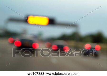 Stock Photo - Blurred tail lights of cars travelling on a highway, Paris, France. Fotosearch
