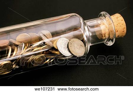 Bottle full of coins lying on its side View Large Photo Image Stock Image - Bottle full of coins lying on its side. Fotosearch