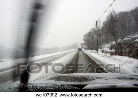 Car driving on a snowy road in the winter View Large Photo Image Stock Image - Car driving on a snowy road in the winter. Fotosearch