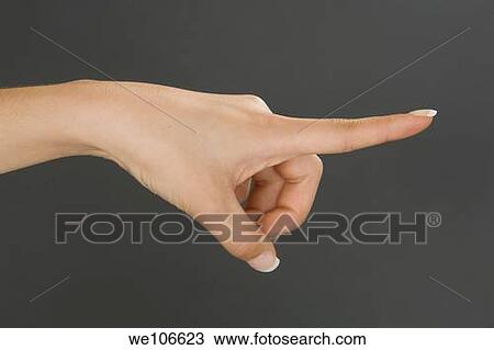 Caucasian female using hand gestures by pointing finger View Large Photo Image Stock Image - Caucasian female using hand gestures by pointing finger. Fotosearch