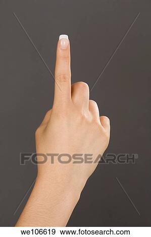 Caucasian female using hand gestures by signing holding up one finger View Large Photo Image Stock Photo - Caucasian female using hand gestures by signing holding up one finger. Fotosearch