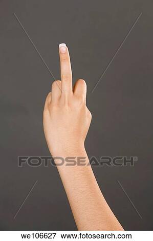 Stock Photo - Caucasian female using hand gestures in anger with the middle finger. Fotosearch