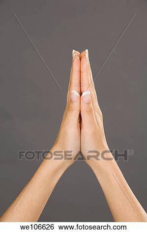 Caucasian female using hand gestures to show praying hands View Large Photo Image Stock Photograph - Caucasian female using hand gestures to show praying hands. Fotosearch