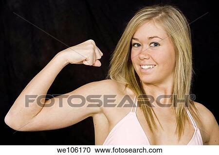 Caucasian teenager wearing a Brazilian cut bikini and flexing her muscle while posing in a studio on a black background View Large Photo Image Stock Image - Caucasian teenager wearing a Brazilian cut bikini and flexing her muscle while posing in a studio on a black background. Fotosearch