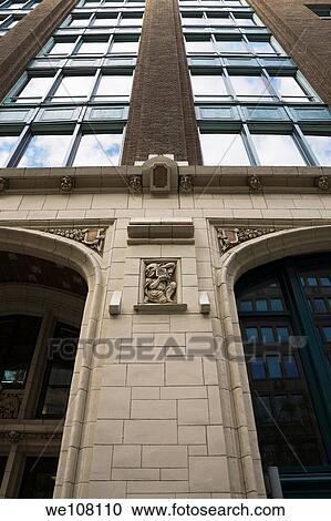 Stock Image - Close-up of a Figurine on the exterior Wall of an Old Architectural Building on Saint-Antoine Street, Old Montreal, Quebec, Canada. Fotosearch