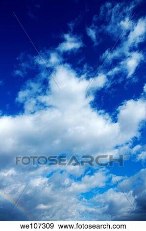 Clouds in a beautiful blue, sunny sky View Large Photo Image Stock Photo - Clouds in a beautiful blue, sunny sky. Fotosearch