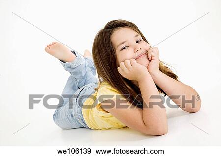 Five year old female child laying on white background smiling wearing casual clothes View Large Photo Image Stock Photo - Five year old female child laying on white background smiling wearing casual clothes. Fotosearch