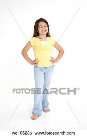 Stock Photography - Five year old female child standing on white background smiling wearing casual clothes. Fotosearch