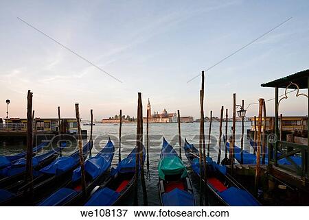 Stock Photo - Gondola moored at Molo San Marco in Venice Italy with San Giorgio Maggiore in the background. Fotosearch