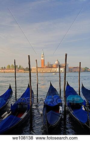 Stock Photo - Gondola moored at Molo San Marco in Venice Italy with San Giorgio Maggiore in the background. Fotosearch