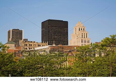 Stock Image - Old Montreal Skyline through Trees at Springtime, Quebec, Canada. Fotosearch