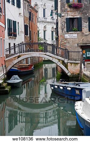 Stock Photograph - One of many canals with typical Venusian architecture in Venice Italy. Fotosearch