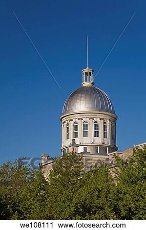 Stock Image - Partial view of Bonsecours Market through Trees, Old Montreal, Quebec, Canada. Fotosearch