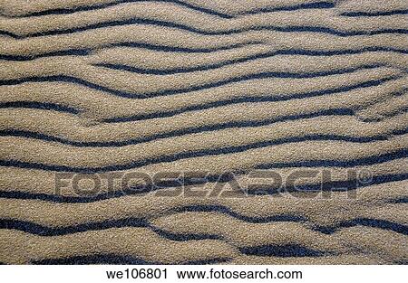 Stock Image - Patterned waves in white sand. Fotosearch
