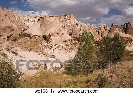 Stock Photo - Pedestal and cone shaped eroded rock formations hardened volcanic ash in the Camel valley, Cappadocia region, Turkey. Fotosearch