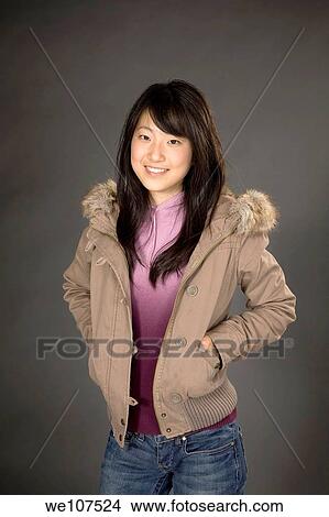 Portrait of a beautiful Asian teenageron gray background View Large Photo Image Picture - Portrait of a beautiful Asian teenageron gray background. Fotosearch