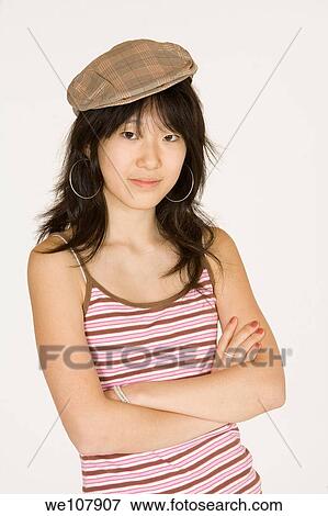 Portrait of a beautiful Asian teenager on a white background View Large Photo Image Stock Photo - Portrait of a beautiful Asian teenager on a white background. Fotosearch