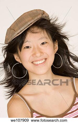 Portrait of a beautiful Asian teenager on a white background View Large Photo Image Stock Photo - Portrait of a beautiful Asian teenager on a white background. Fotosearch