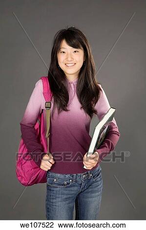 Stock Image - Portrait of Asian teenager getting ready to go to school. Fotosearch
