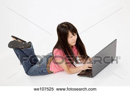 Portrait of Asian teenager working with a laptop conputer on a white background View Large Photo Image Stock Photography - Portrait of Asian teenager working with a laptop conputer on a white background. Fotosearch