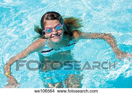 Preteen girl enjoying a day at the swimming pool View Large Photo Image Picture - Preteen girl enjoying a day at the swimming pool. Fotosearch