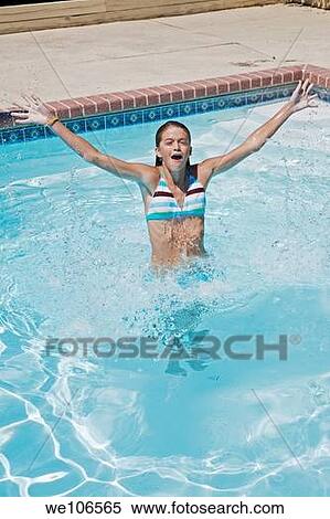 Preteen girl enjoying a day at the swimming pool View Large Photo Image Stock Photography - Preteen girl enjoying a day at the swimming pool. Fotosearch