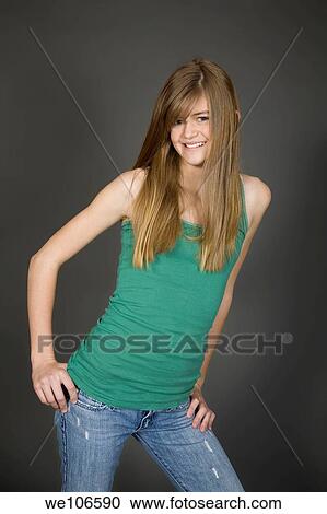 Preteen girl posing on gray background with some attitude View Large Photo Image Stock Image - Preteen girl posing on gray background with some attitude. Fotosearch