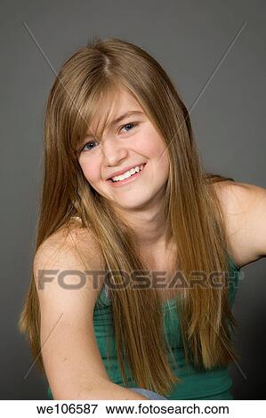 Stock Photo - Preteen girl posing on gray background with some attitude. Fotosearch