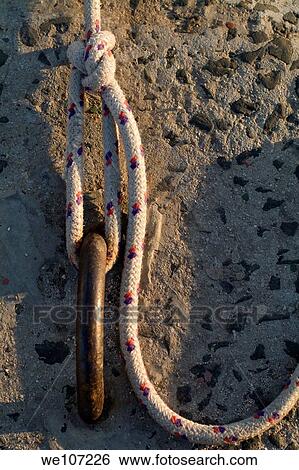 Rope tied to a mooring ring View Large Photo Image Stock Photograph - Rope tied to a mooring ring. Fotosearch